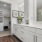 a bathroom with white cabinets