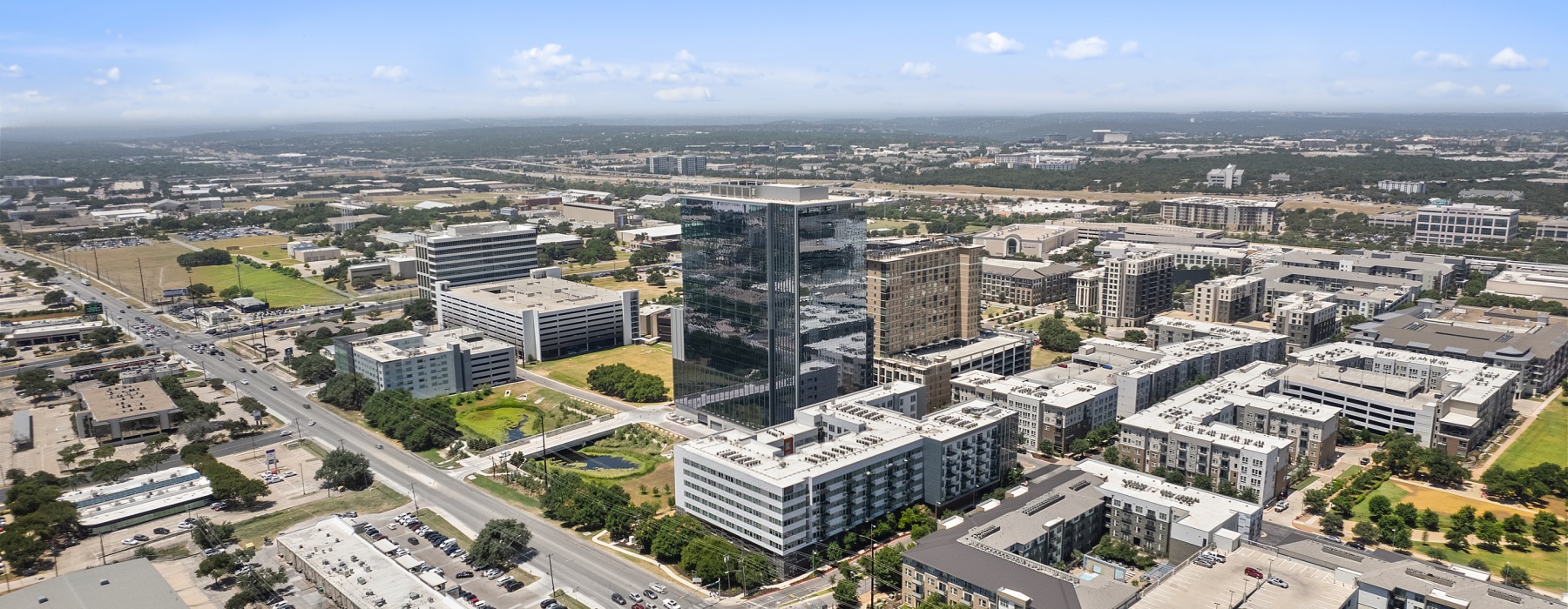 Drone view of building and it's surrounding neighborhood 