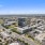 Drone view of building and it's surrounding neighborhood 