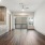 Large living room overview with brown cabinets to the left within a kitchen