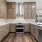 Overview of kitchen with brown cabinets and stainless steel appliances