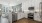 Kitchen with white cabinets and stainless steel appliances overlooking living room