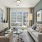 Living room with couch and lounge chair with big window overlooking courtyard