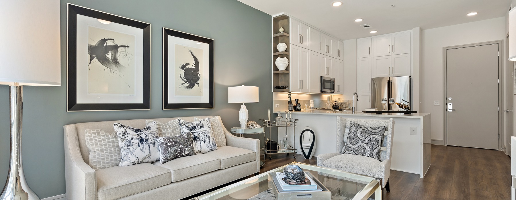 Living room with couch, lounge seats  with kitchen overlooking it