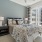 Bedrom with queen sized bed, two nightstands and big window overlooking courtyard