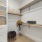 Walk-in closet with hang up racks and built-in shelving