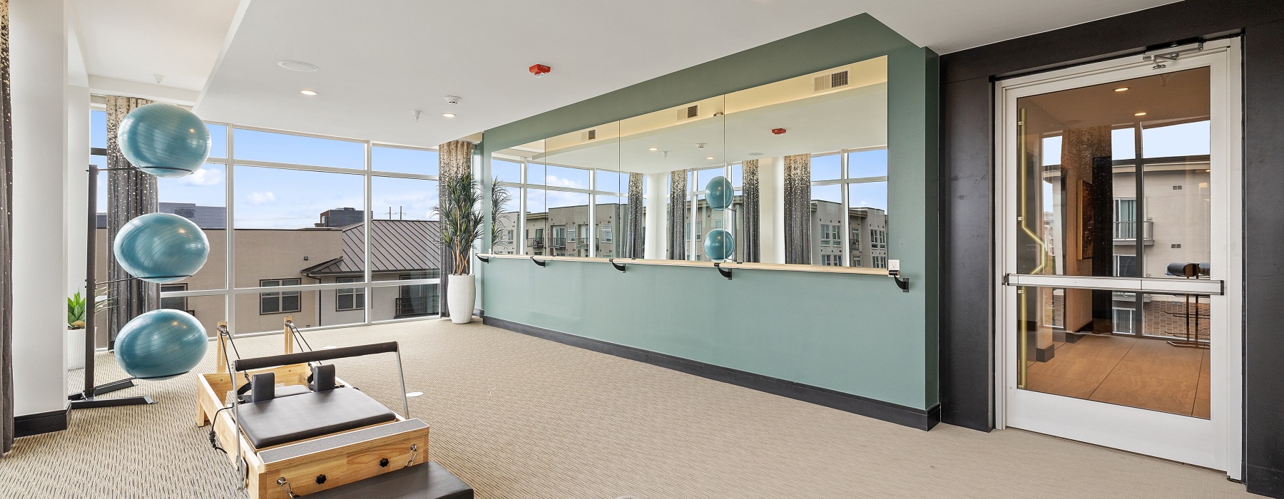 a room with a large window and a large carpeted floor