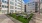 a courtyard with tables and chairs and buildings in the background